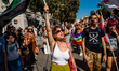 Citizens wave flags and hold signs as they protest in a march in support of Palestine in B...