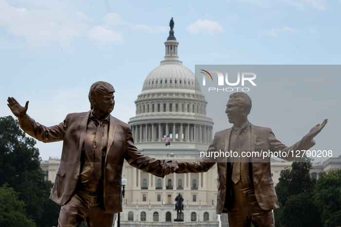 Statues of Trump and Epstein appear in front of U.S. Capitol