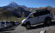 A view of the Mount Kazbek as buses are seen parked near the Gergeti Trinity Church in Ste...