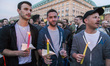 People hold memorial candles in front of Brandenburg Gate during an evening vigil in Berli...