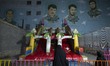 Iranian children play in a playground under images of Iran-Iraq war (1980-1988) martyrs du...