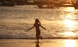 A girl runs as she plays at Kedonganan Beach in Jimbaran, Bali, on September 26, 2025. Ked...