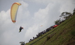 A paragliding athlete soars with the backdrop of Jatigede Reservoir during the West Java P...