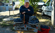 CHISINAU, MOLDOVA – SEPTEMBER 27, 2025: A local man selling grapes outside his property is...