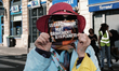 Protesters hold placards as they march during the demonstration ''Climate, Justice, Freedo...
