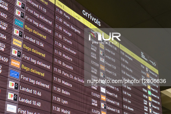 A screen shows the arrival flights at Lisbon Airport in Lisbon, Portugal, on September 28, 2025, as several incoming flights are canceled du...