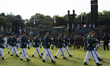 The honor guard marches in for the event with, from left to right in the background, Cheon...