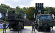Military equipment is on display at the event, with a Cheongung-II missile visible, during...