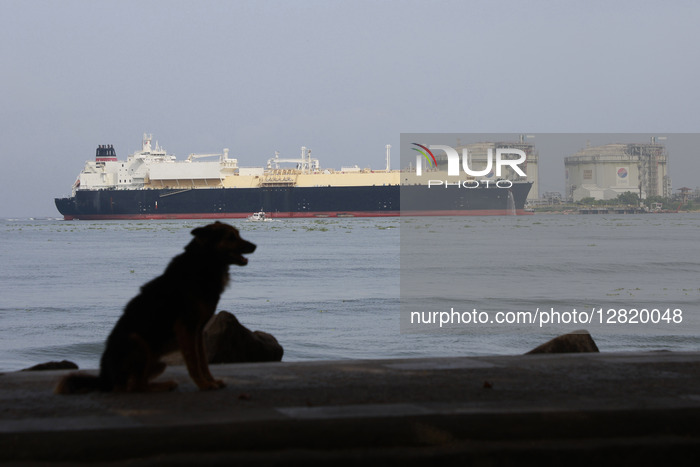 Fisherman In Fort Kochi Beach In The Backdrop Of LNG Tanker
