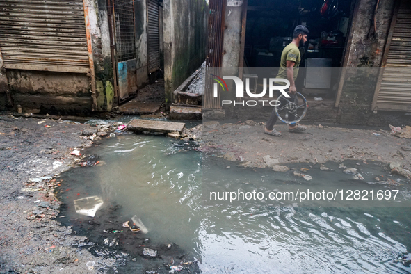 People suffer as stagnant drain water overflows onto the streets throughout the year, worsening during rains in Dhaka, Bangladesh, on Octobe...