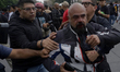 A cameraman is attacked by the Black Anarchist Bloc and police in Mexico City, Mexico, on...