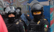 Riot police participate in a demonstration to commemorate the 57th anniversary of the mass...