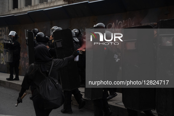 An anarchist sprays against police during a protest commemorating the 57th anniversary of the 1968 Student Massacre at the Plaza de las Tres... by Eyepix/NurPhoto