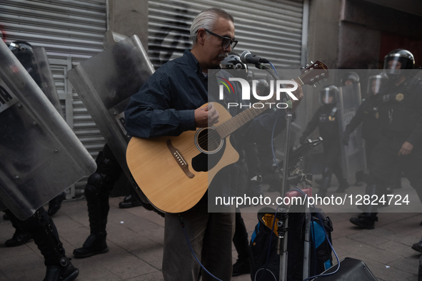 A man plays guitar during a protest commemorating the 57th anniversary of the 1968 Student Massacre at the Plaza de las Tres Culturas in Tla... by Eyepix/NurPhoto