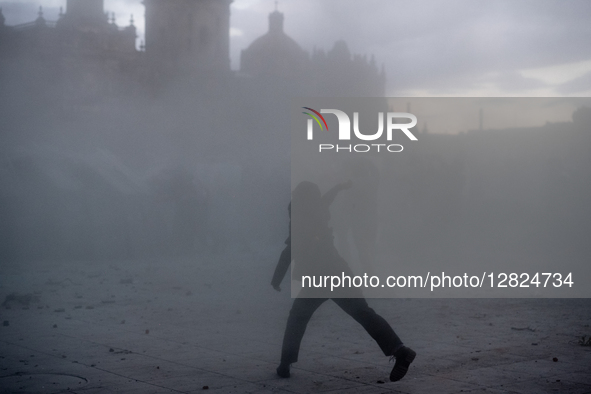 An anarchist throws a stone at riot police during a protest commemorating the 57th anniversary of the 1968 Student Massacre at the Plaza de... by Eyepix/NurPhoto