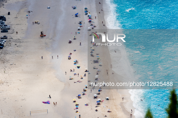 Visitors are seen on the sandy shore of Myrtos Beach on September 6, 2025 in Kefalonia, Greece. 
