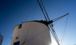A traditional white windmill with sails stands on a hilltop in Chora on September 16, 2025...
