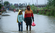 Displaced residents living along the riverbanks flowing through the Kathmandu Valley wade...