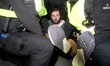 A protestor is arrested and carried away by police at Trafalgar Square in London, England,...
