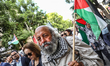 A Tunisian pro-Palestinian man holds up the Palestinian flag as he attends a demonstration...