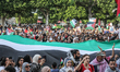 Pro-Palestinian Tunisians chant slogans while waving Palestinian flags as they demonstrate...