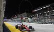 Scuderia Ferrari driver #44 Lewis Hamilton (GBR) drives along the pit straight past the il...