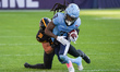 Wide receiver Janarion Grant #3 of the Toronto Argonauts is pressured by LB Braxton Hill #...