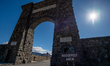 Visitors are seen at the Roosevelt Arch at the north entrance of Yellowstone National Park...