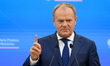 Polish Prime Minister Donald Tusk gestures as he takes part in a press briefing with Lithu...