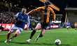 Zeno Ibsen Rossi of Cambridge United challenges Jordan Clark of Luton Town during the Vert...