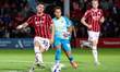 Rico Browne of Walsall passes the ball as Elliott List of Northampton Town closes in durin...