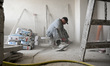 A builder carries out finishing works in an apartment block at 2A Zaporizka Street, where...