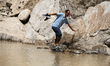 Nepali travelers walk across the cliffs as they navigate the flooded section of the BP Hig...