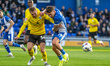 Ben Whitfield from Barrow and Luke Hannant from Oldham Athletic battle for possession duri...