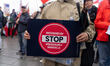 A demonstration 'Stop Illegal Migration, No To Mercosur'er holds a placard saying ''Stop m...