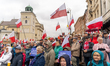 People wave Poland national flags and shout slogans during the rally. 