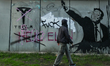 BUCHAREST, ROMANIA – OCTOBER 10:A mural in the style of Banksy depicting Elon Musk making...