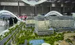 Visitors view models of a new building at the 'Cityscape Qatar 2025' real estate exhibitio...