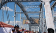 People are seen along the Purple People Bridge during America's River Roots Festival on th...