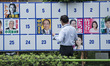 Poster board for Julys House of Councillors election in Tokyo A man looks at campaign post...