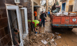 Residents of the town of Godall clean houses and streets after flooding caused by DANA Ali...