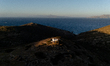Drone photo showing the chapel and the Tomb of Homer site at sunset on Ios Island, Greece,...