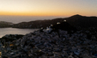 Drone view of Chora, the main town of Ios Island, at sunset, with its hilltop churches ove...