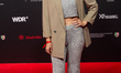 Anna Roeser, a German actress, poses for pictures on the red carpet before the award cerem...