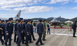 A General Dynamics F-16 Fighting Falcon is displayed behind South Korean Air Force personn...