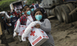 Members of the Mexican Red Cross provide humanitarian aid to people affected by floods in...