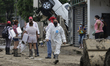 Families clean up after being affected by floods in Poza Rica, Veracruz, on October 17, 20...