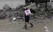 People receive kits from the Mexican Red Cross in Poza Rica, Veracruz, on October 17, 2025...