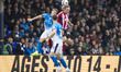 Ilmari Niskanen #14 of Exeter City F.C. and Ben Osborn #23 of Stockport County F.C. engage...