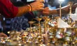 People shop for bronze and other metal items at a roadside stall on Dhanteras, in Guwahati...